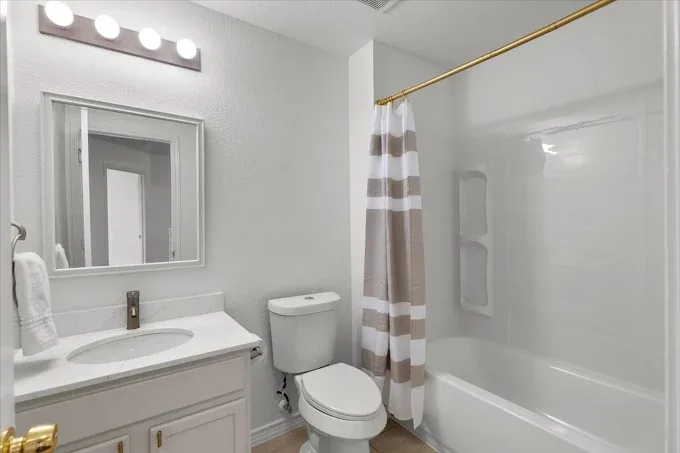 Home remodel in Tarrytown TX featuring open-concept living space, modern kitchen, hardwood floors, and landscaped backyard.