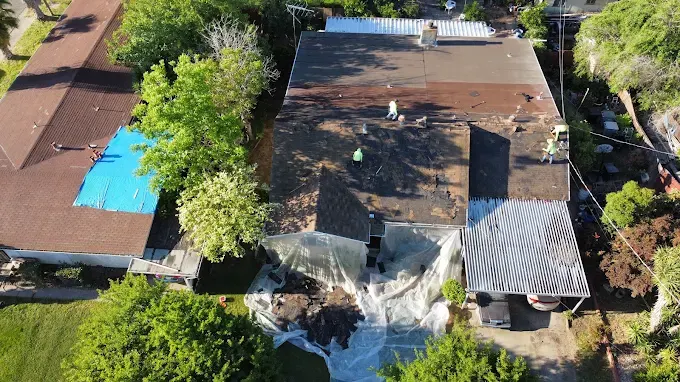 Recently repaired suburban home in Modesto with new dark shingle roof, cozy siding, lush yard, under a blue sky