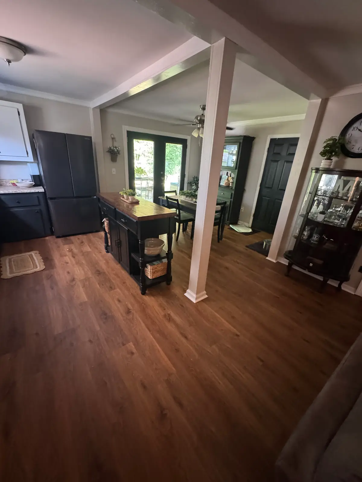 Spacious sunlit living room in Cohutta, GA featuring polished hardwood floors, stylish furniture, and minimalistic decor.