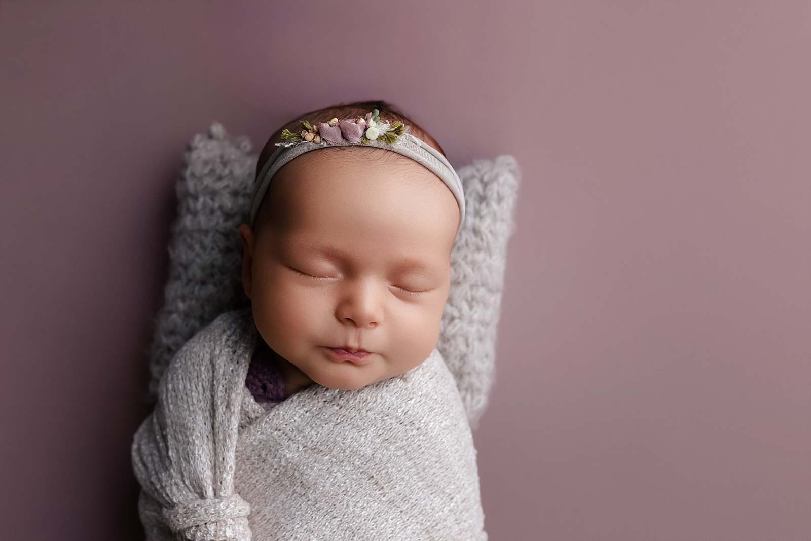 Newborn photo after baby acne and flaky skin retouching with natural texture preserved