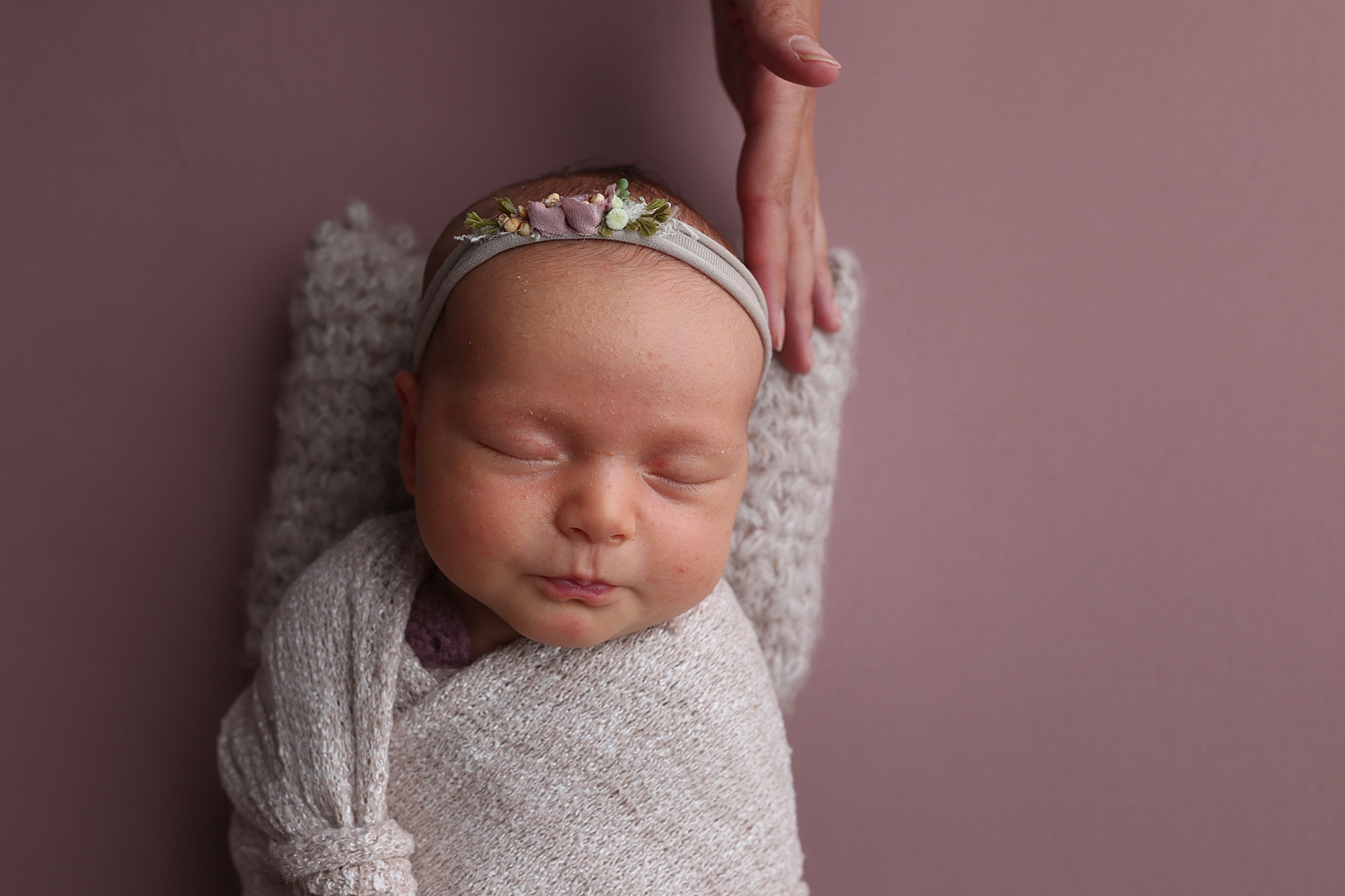 Newborn photo before retouching showing baby acne and flaky skin