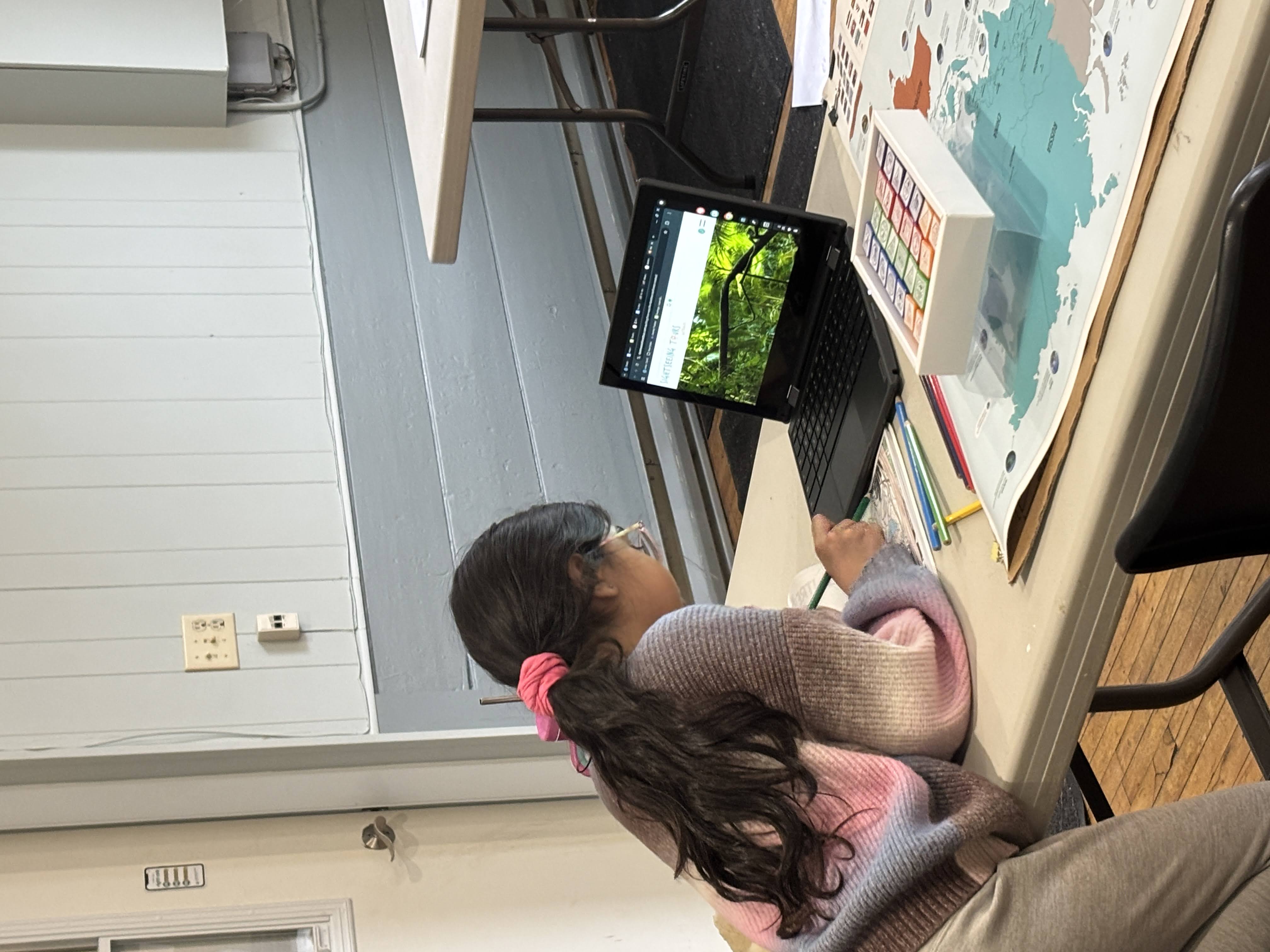 Children using a mix of technology and hands on materials to learn about the world during our cartography quest.