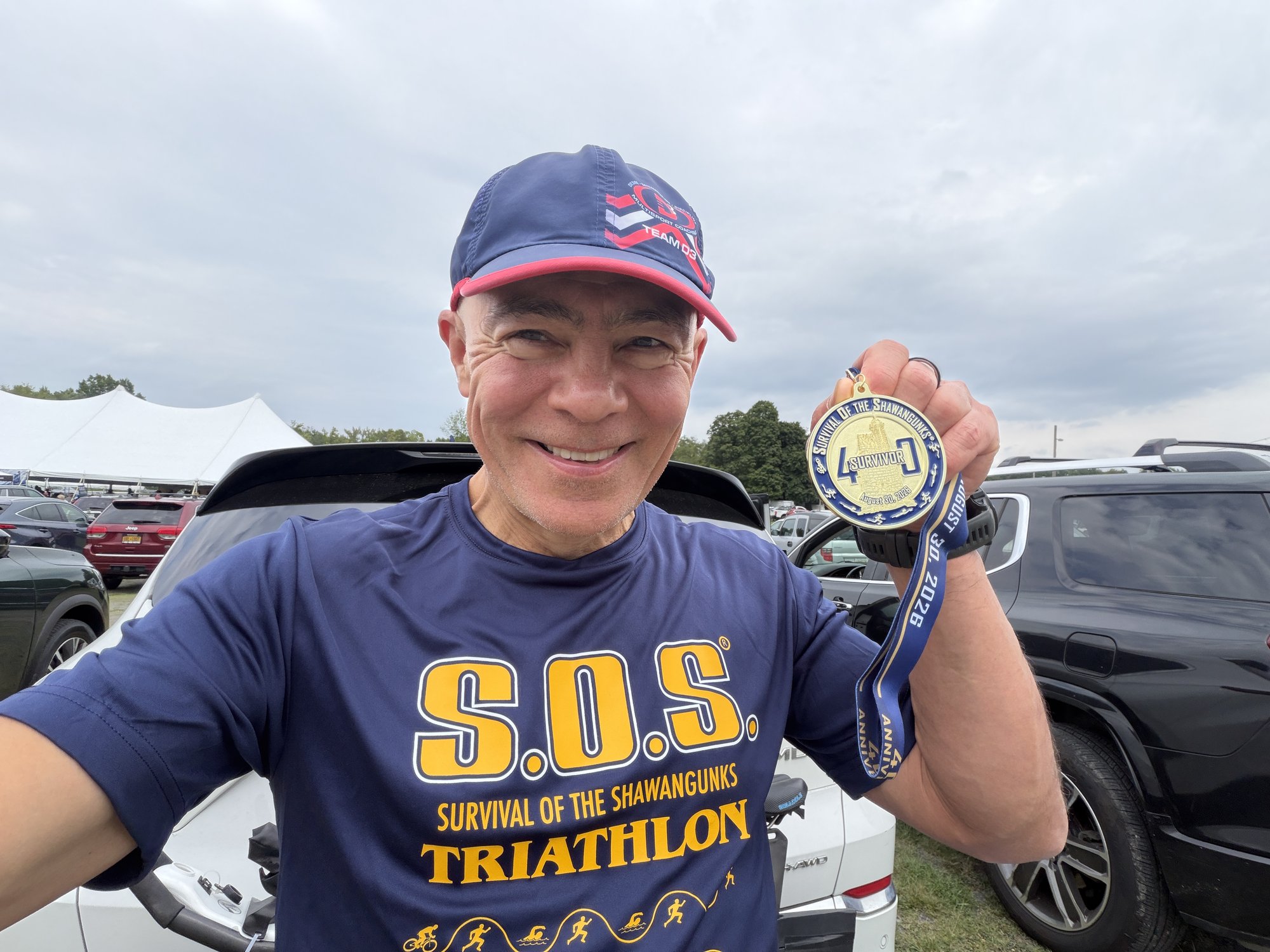 Igor holding his S.O.S. Triathlon 2026 finisher medal. Igor holding his S.O.S. Triathlon 2026 finisher medal.