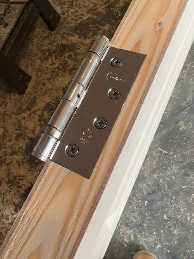 Stainless steel door hinge fitted during internal joinery work in Halesowen
