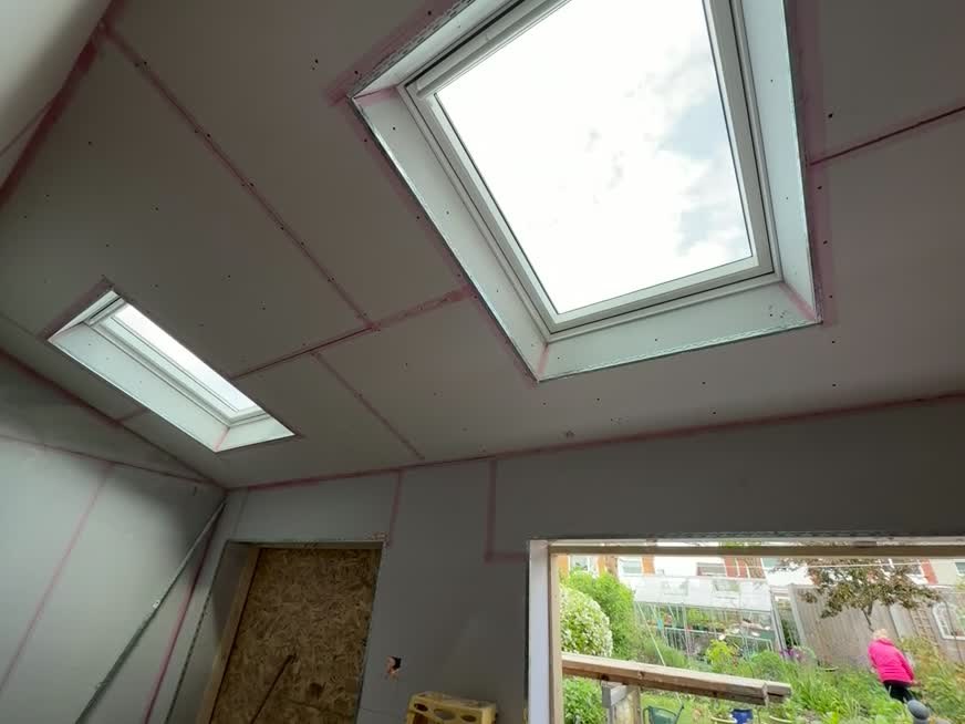 Two Velux roof windows installed in a newly plasterboarded ceiling in Halesowen
