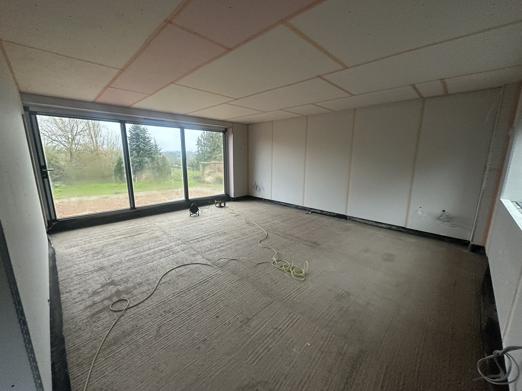 Dried liquid screed floor ready for finishes at the Solihull Road renovation