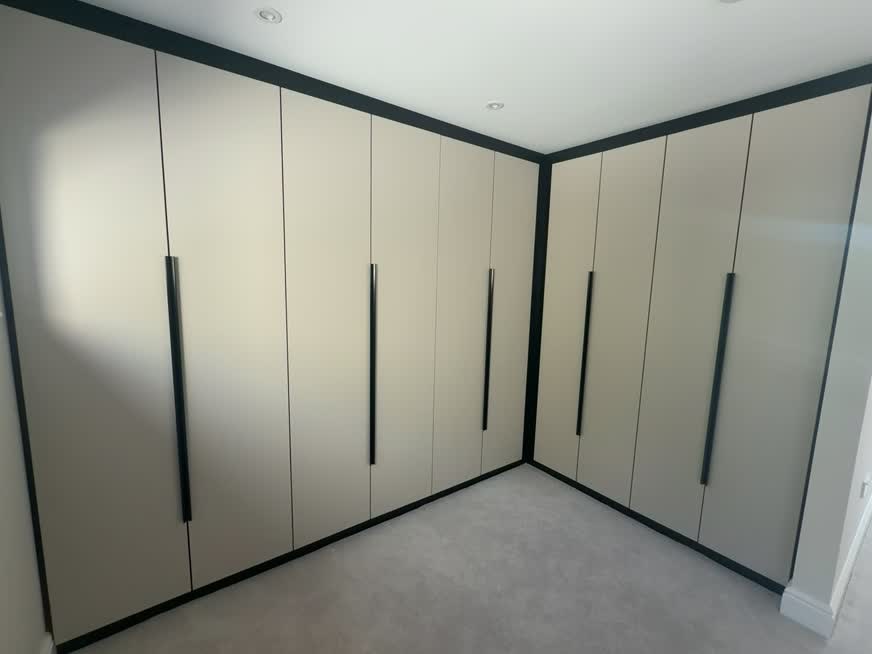 Full-height fitted wardrobes with black handles at the Solihull Road renovation