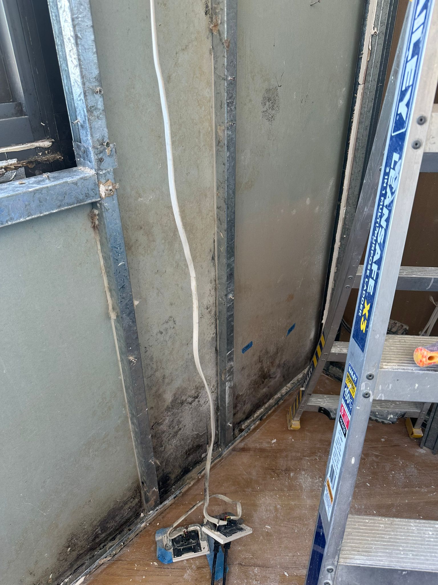 Extensive mould growth inside wall framing and behind gyprock requiring professional remediation and containment