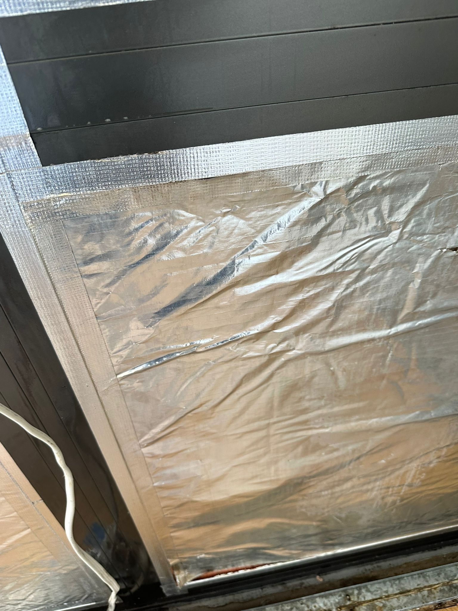 Sealed containment setup around window area during mould remediation to prevent spread of airborne spores