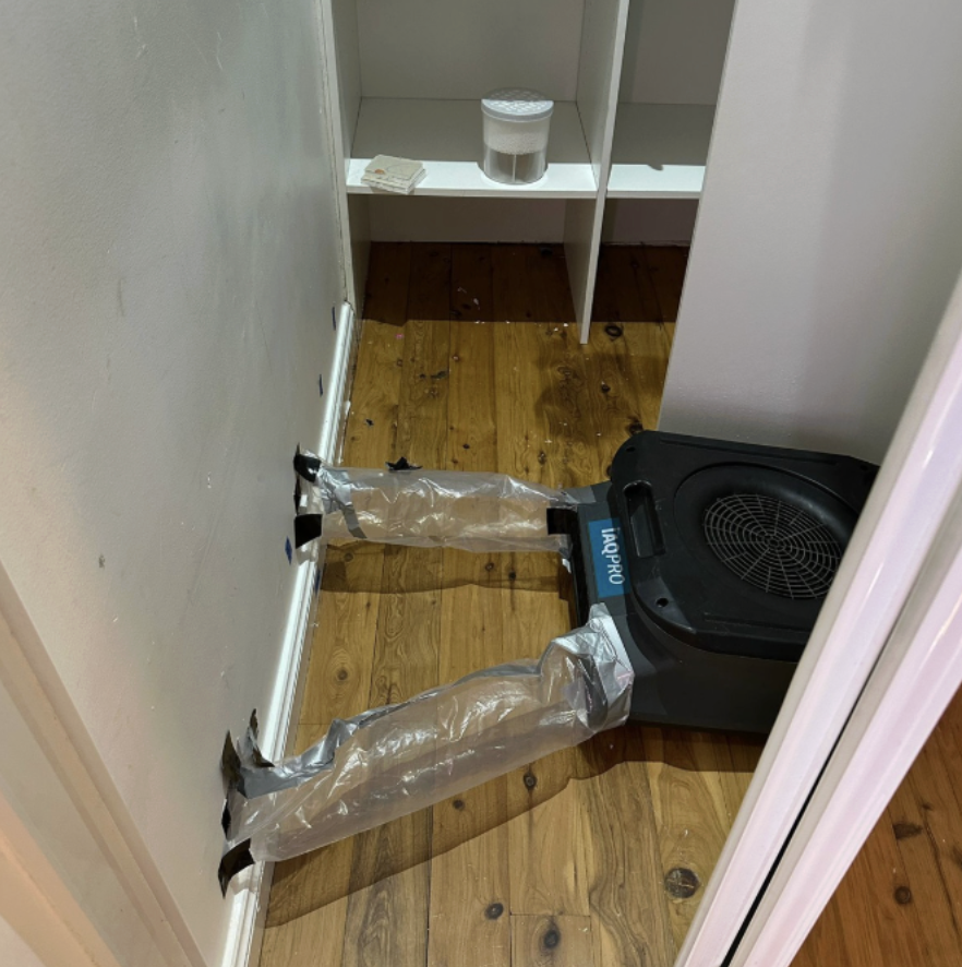 Structural drying equipment directing airflow into an internal wall cavity during moisture remediation at a residential property in Edensor Park.