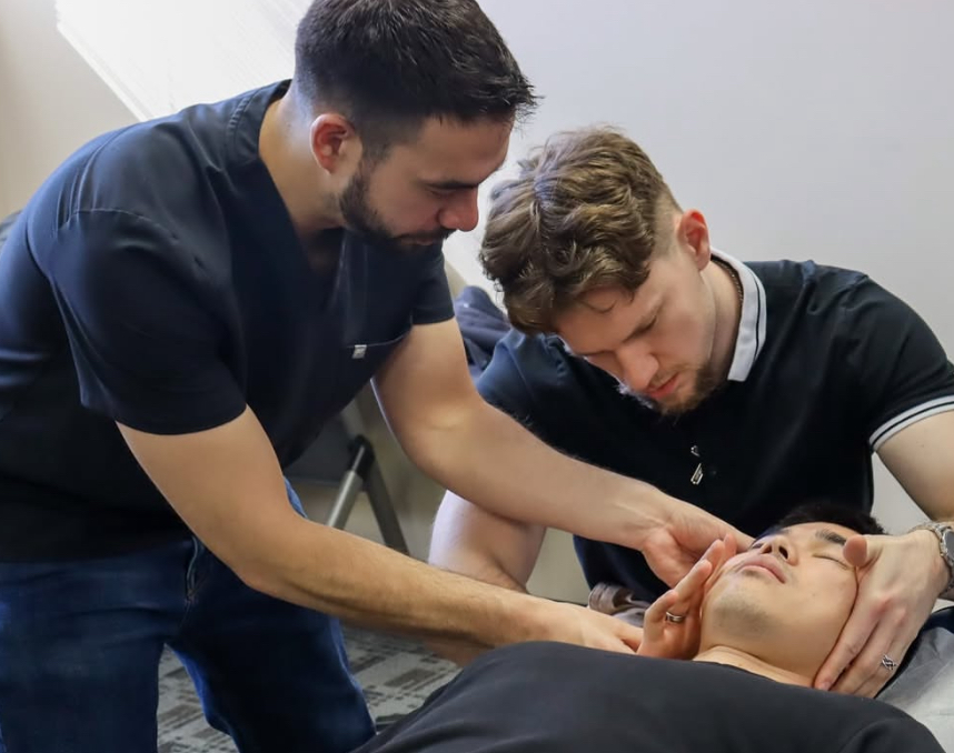 Dr. Bruna coaching a student at the Adjusting Lab