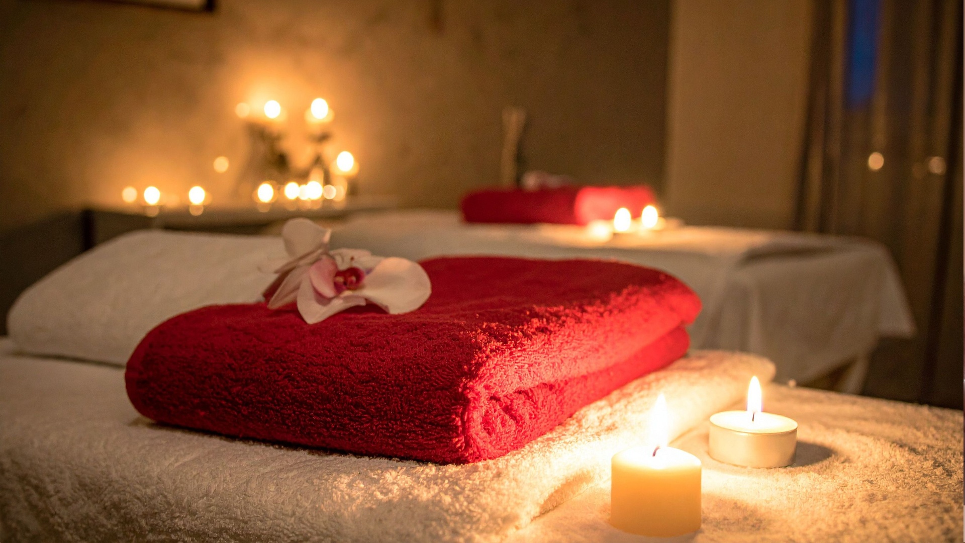 Warm, candlelit luxury massage setup in a Miami suite