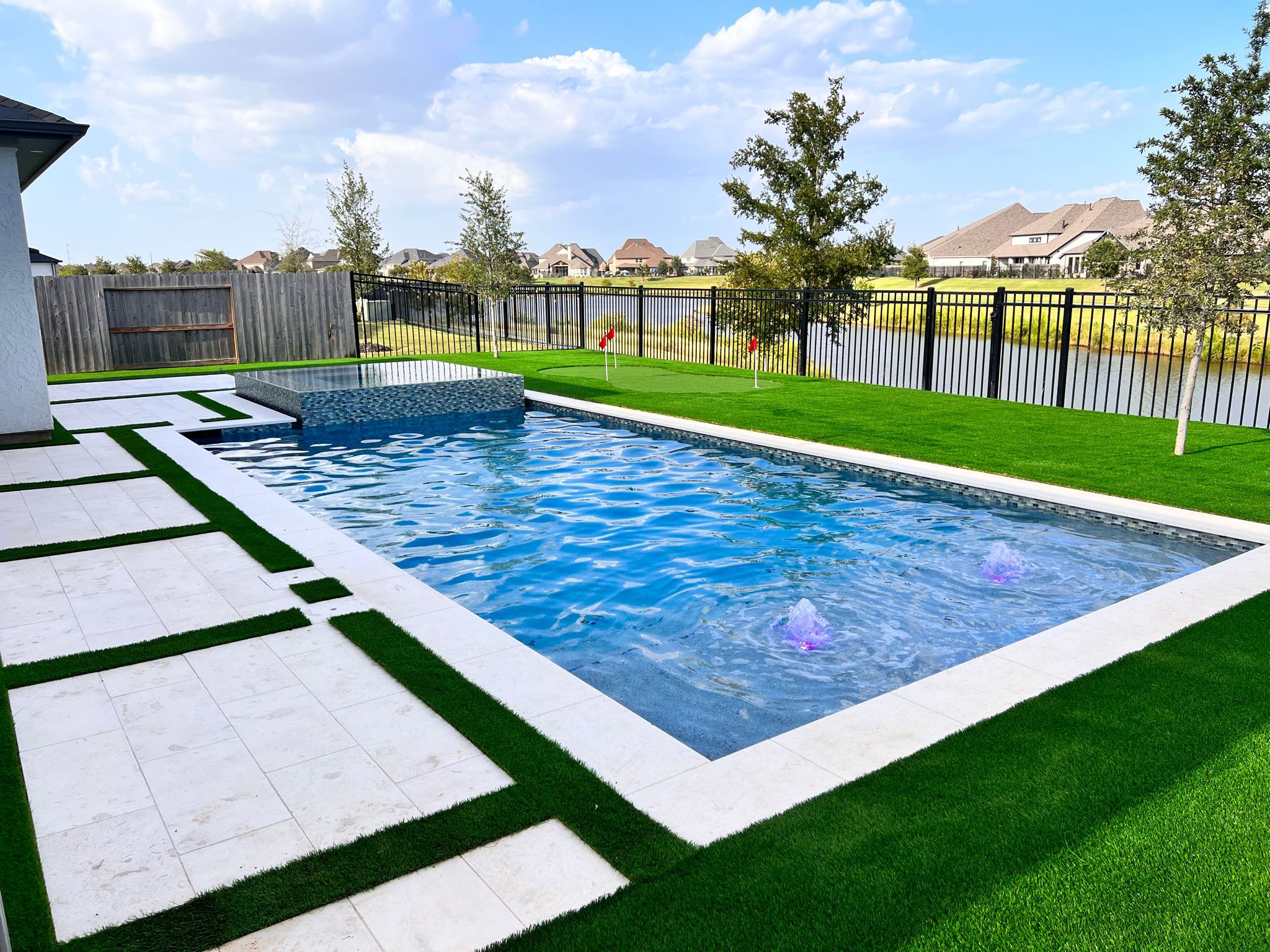 Custom pool with elevated spa and landscaping