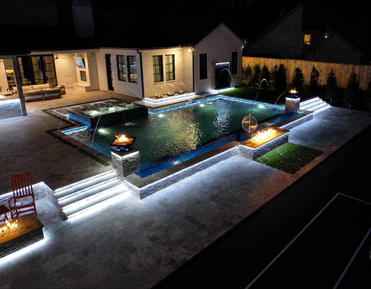 The same custom pool lit up at night