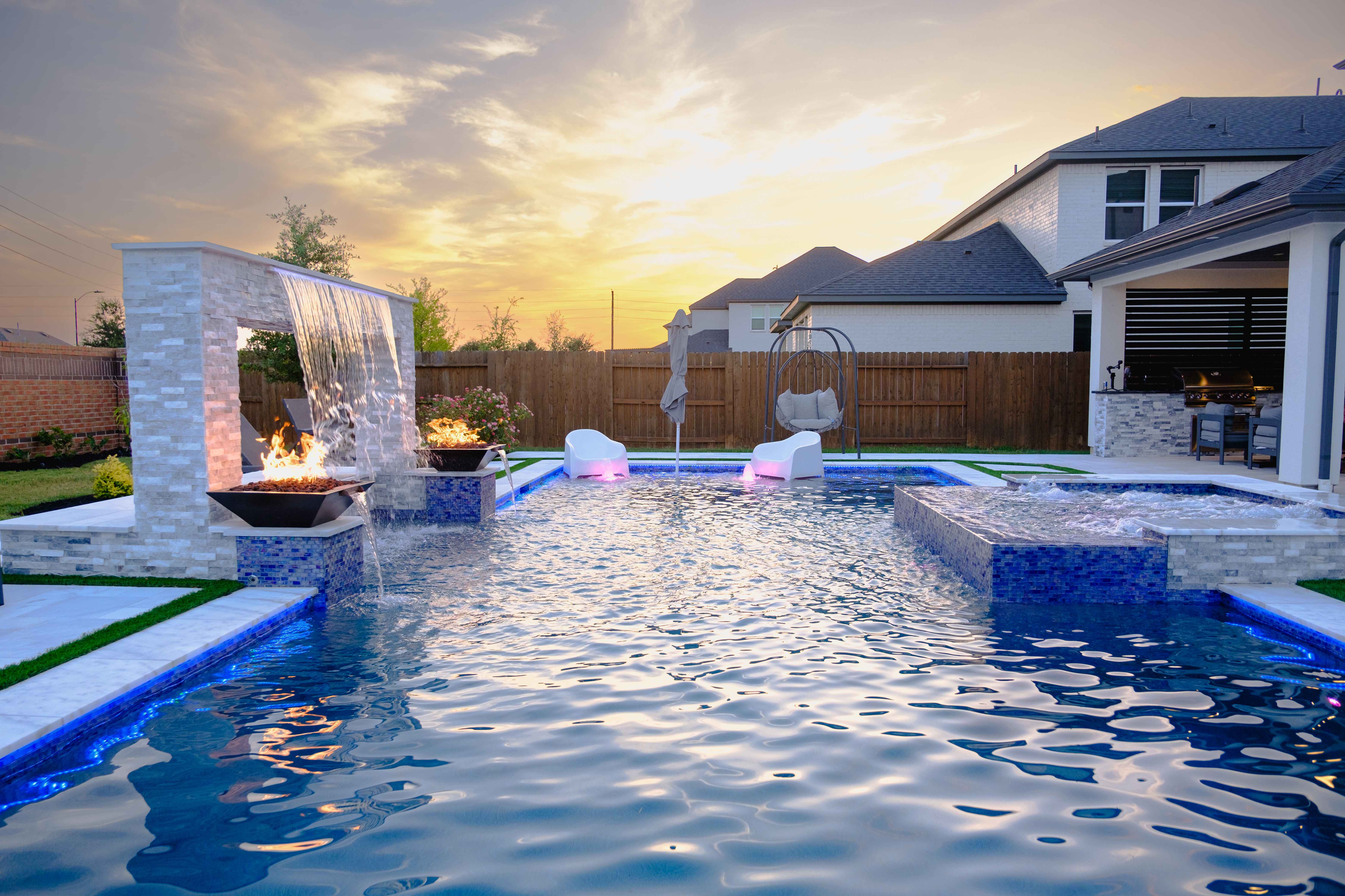 Complete backyard with pool, spa, outdoor kitchen and fire features by Power Vision Pools