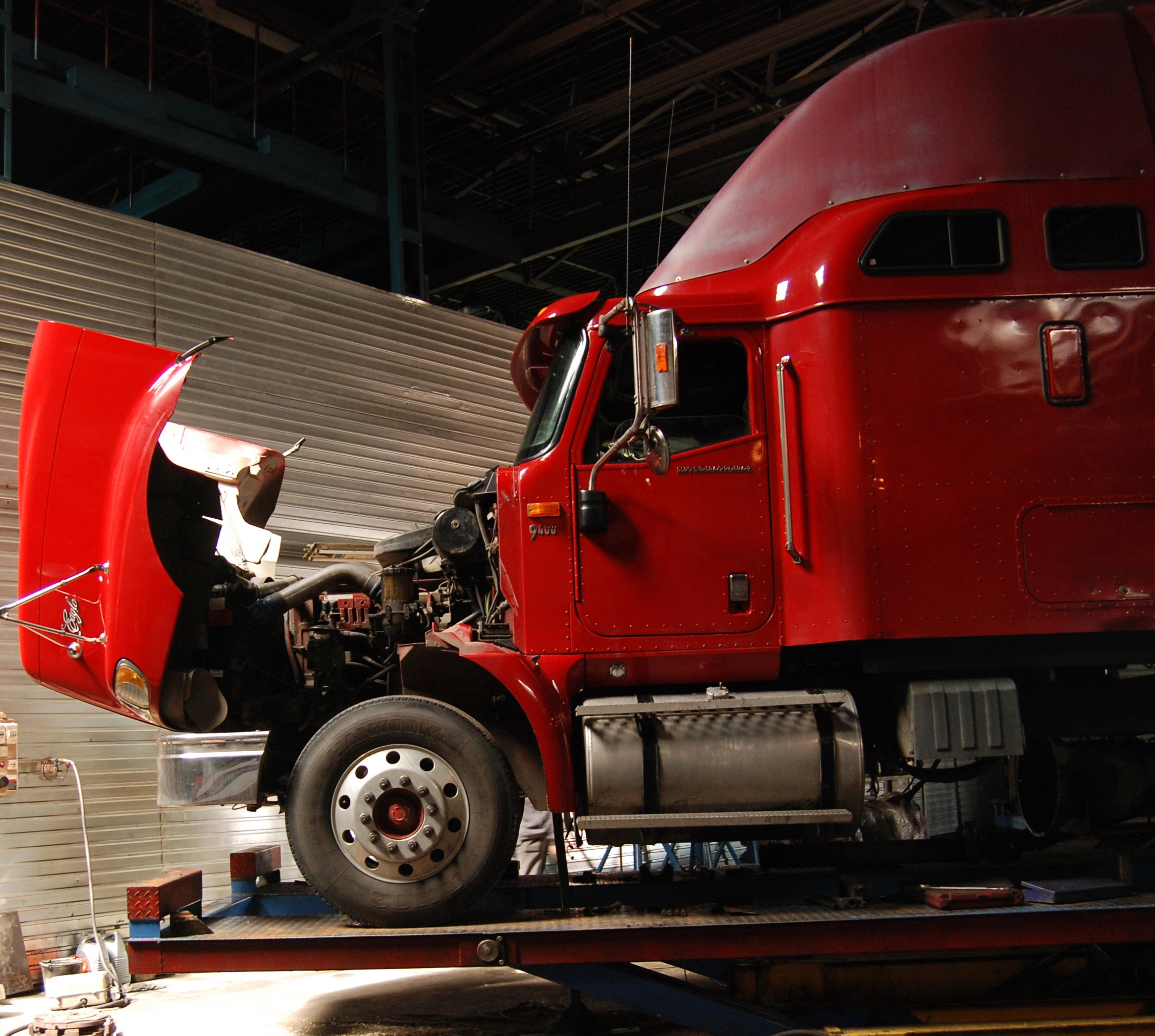 Diesel technician repairing commercial truck roadside on-site