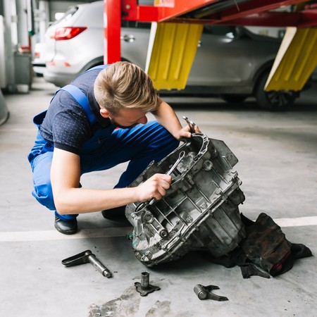 Mobile diesel technician repairing heavy duty commercial truck