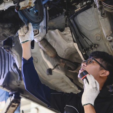 Technician performing mobile truck maintenance on commercial vehicle