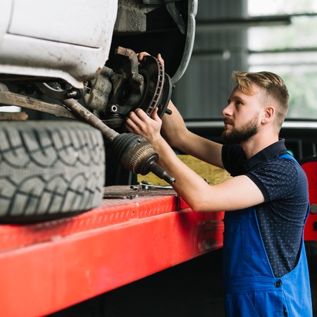 Mobile diesel technician repairing commercial truck on-site