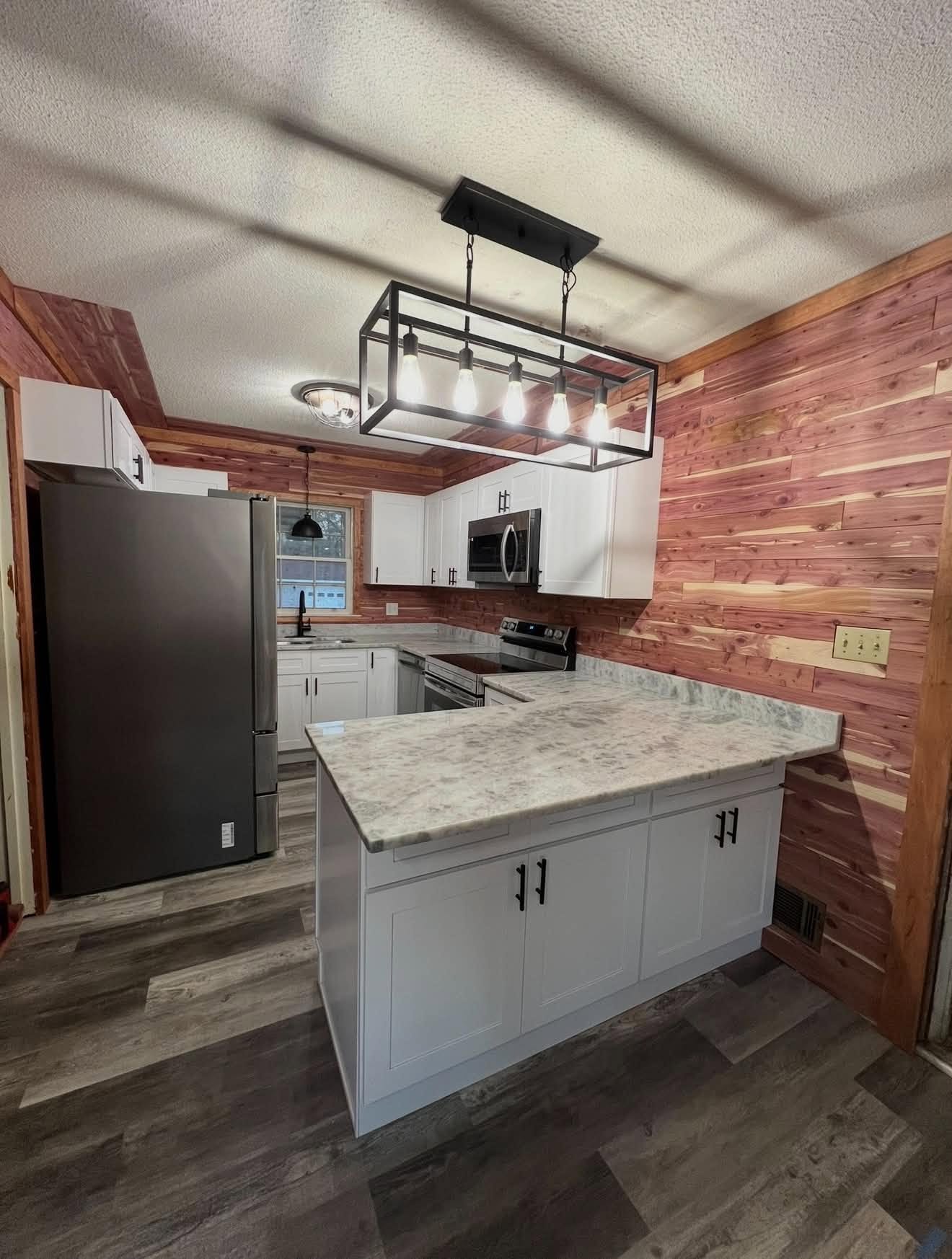 Kitchen remodel with new cabinetry, countertops, and a finished island — before