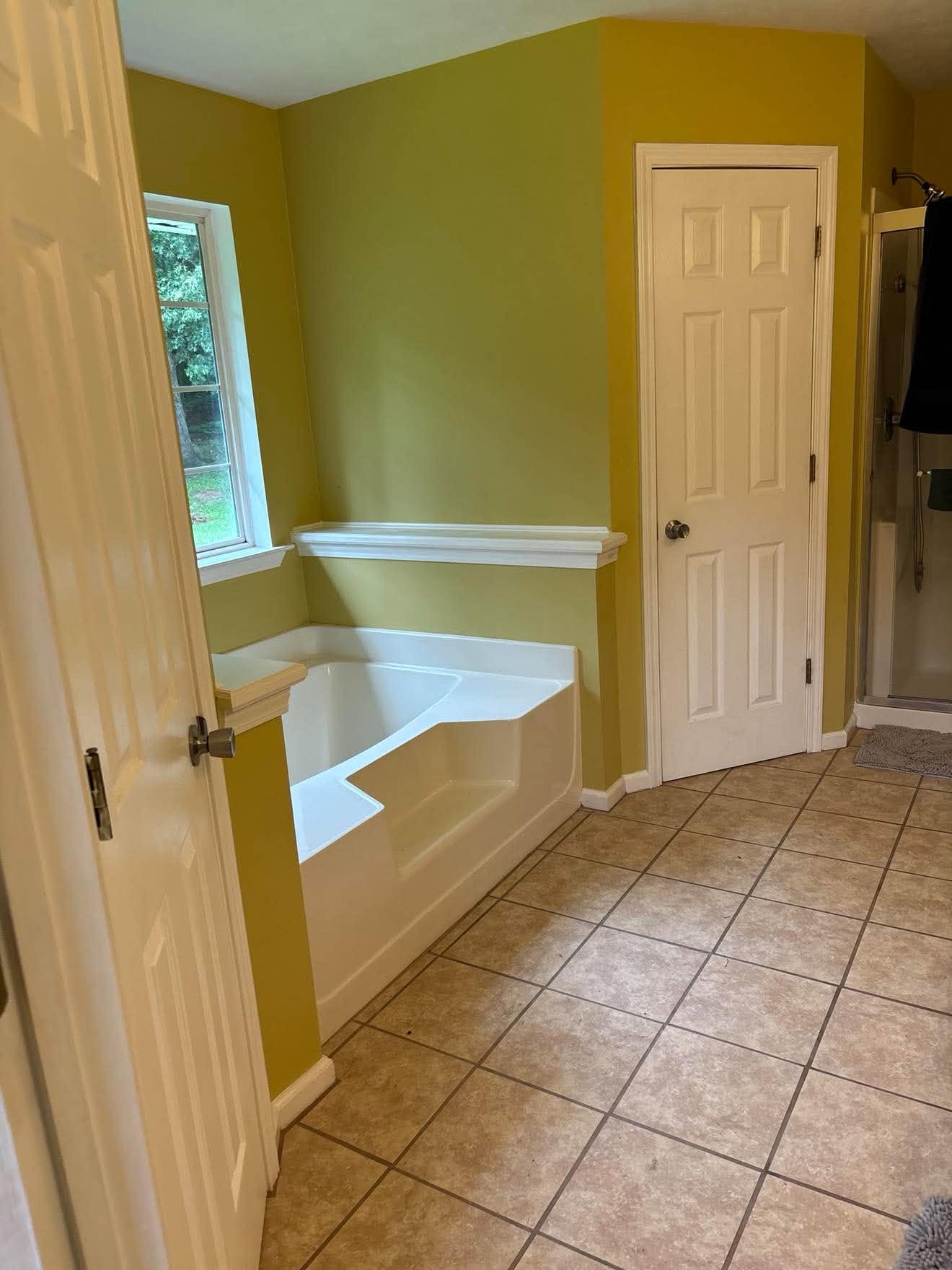 Bathroom remodel with new flooring, replaced tub and plumbing — after
