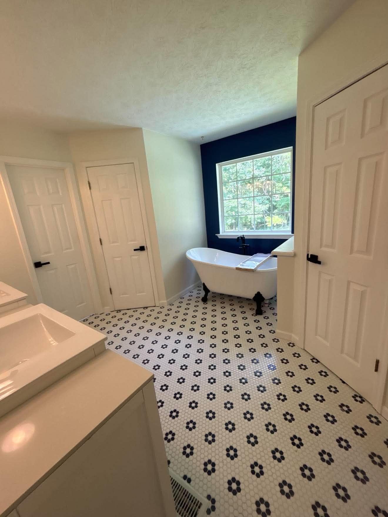 Bathroom remodel with new flooring, replaced tub and plumbing — before