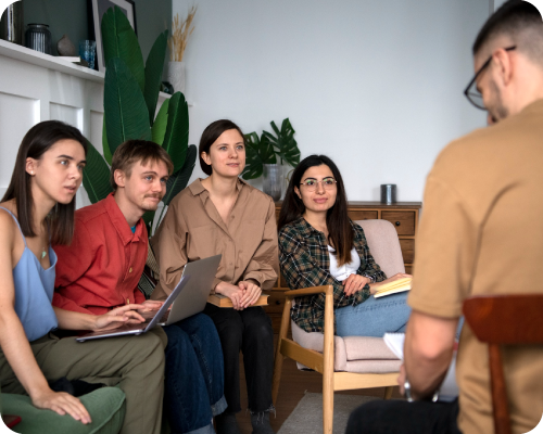 Graduate counseling interns and mentors in a supportive training session.