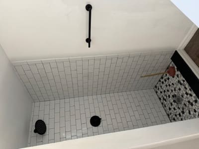 white freshly tiles shower