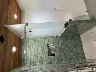 High-end bathroom remodel with fresh green tiles