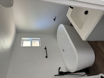 All white bathroom with bathtub