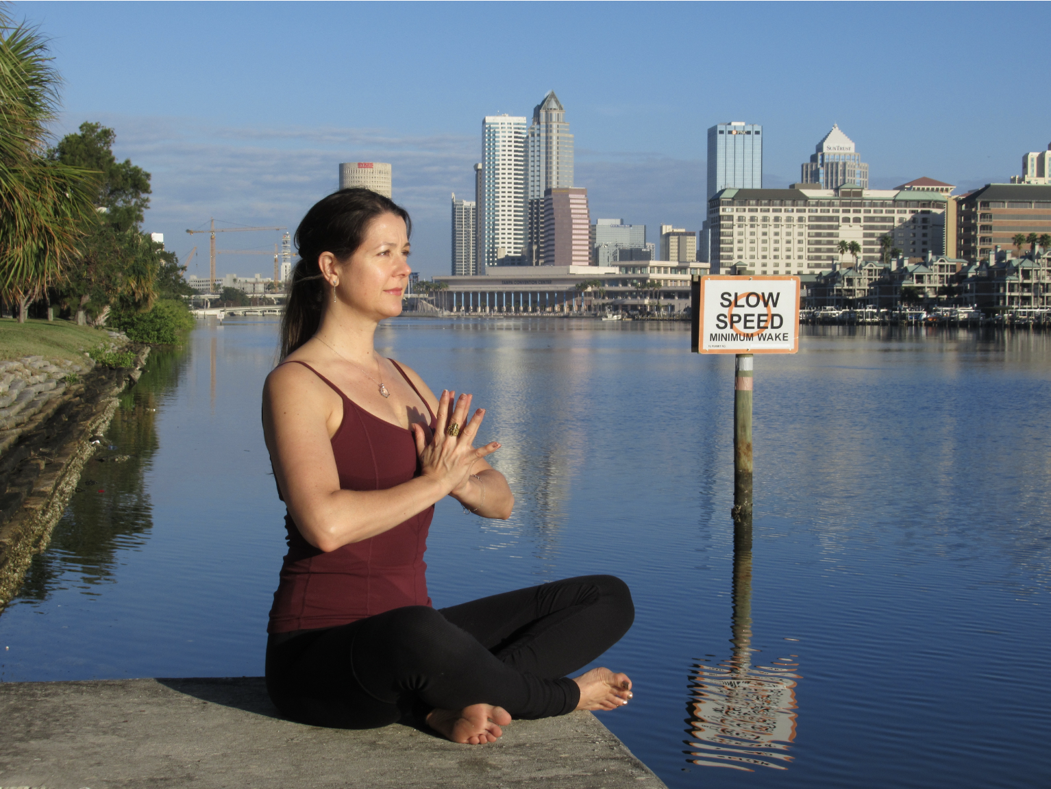 Natalie in yoga pose looking at river