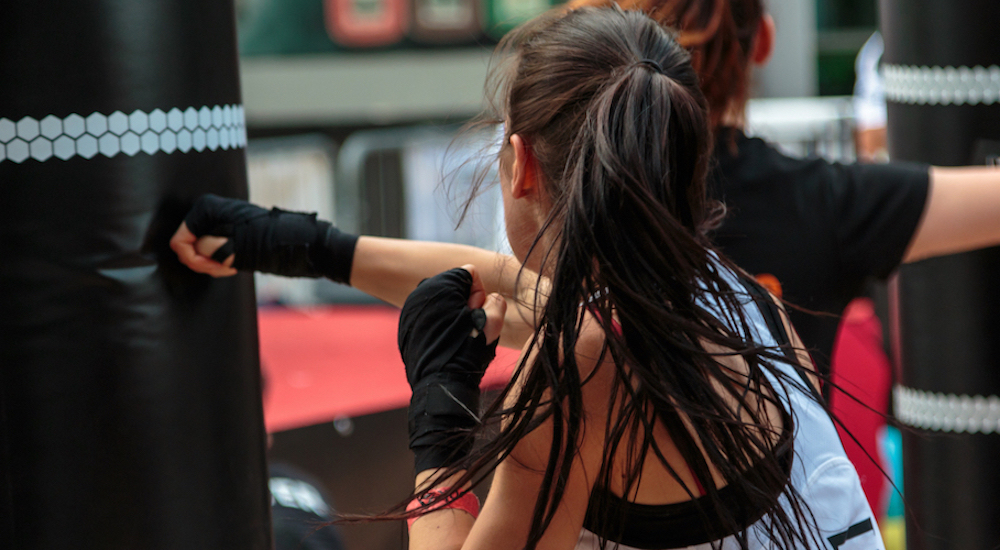A Powerhouse karate instructor training with a young student