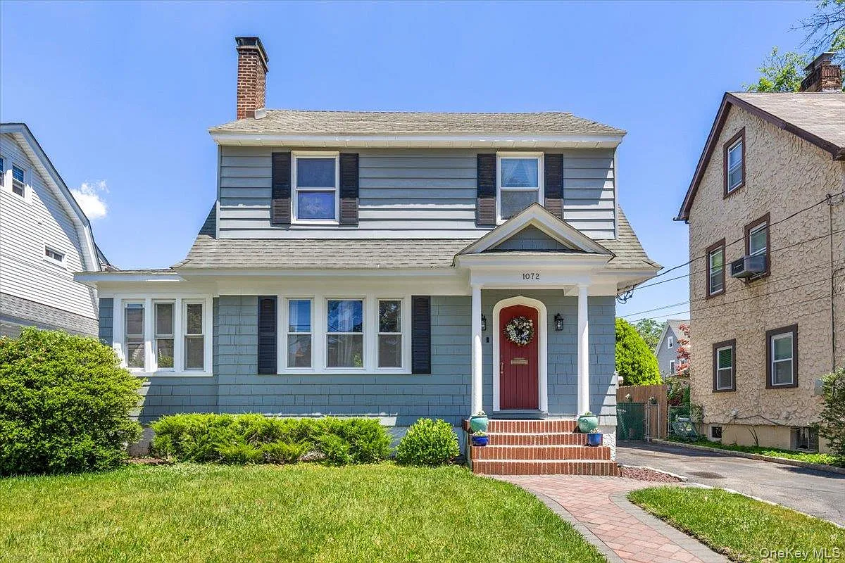 Cape-style home with paver walkway in Westchester County, on the cover of the Home Seller's Guide