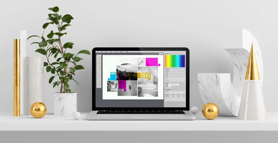 Pent dekorert hylle med bærbar PC som brukes til et designprosjekt