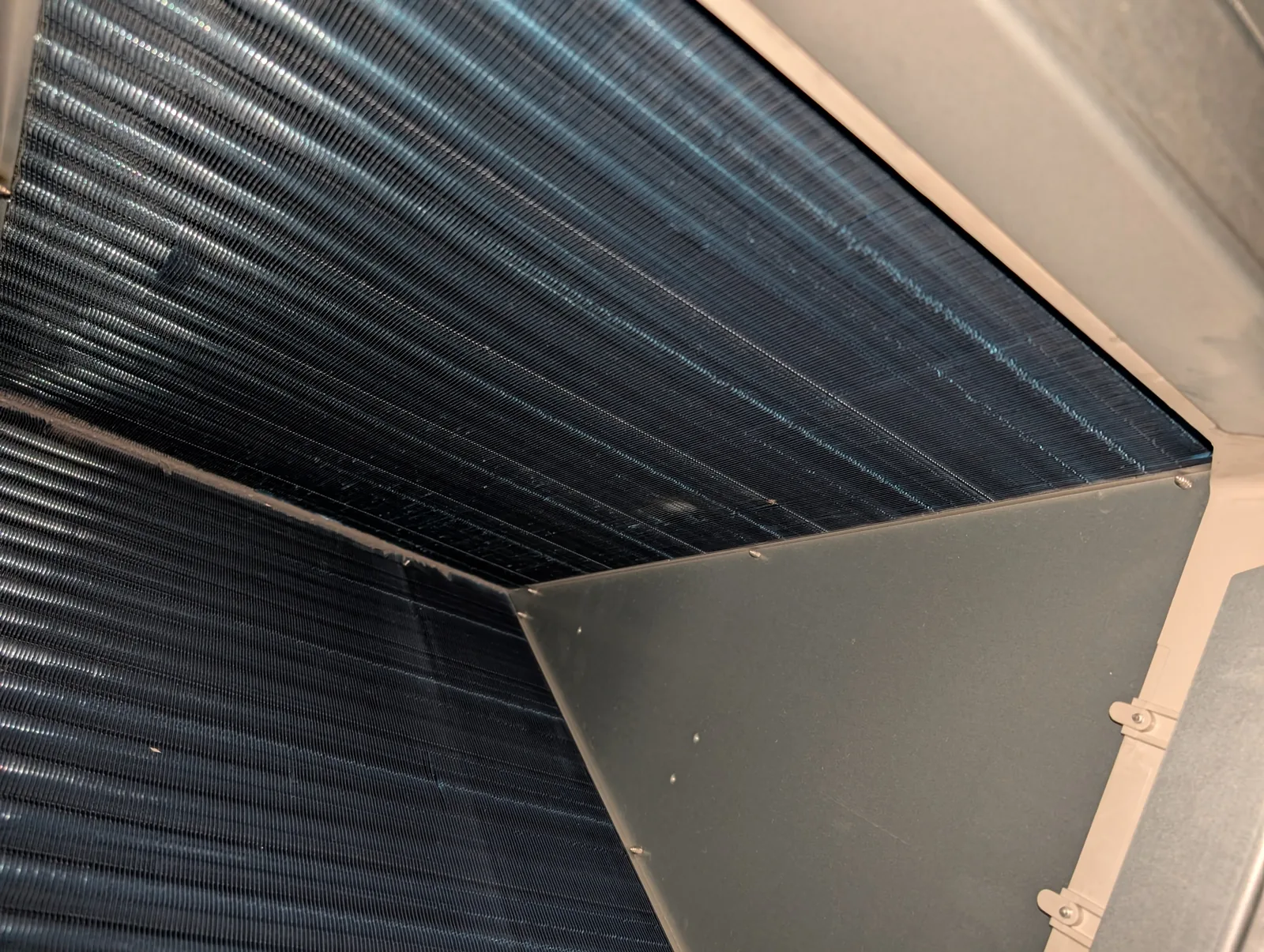 Clean evaporator coil inside an air handler after service in Freehold, NJ