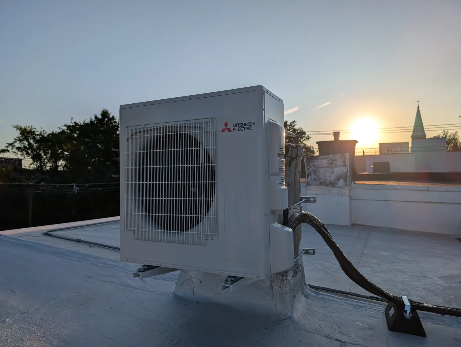Mitsubishi mini split condenser on a rooftop at sunset, Monmouth County, NJ