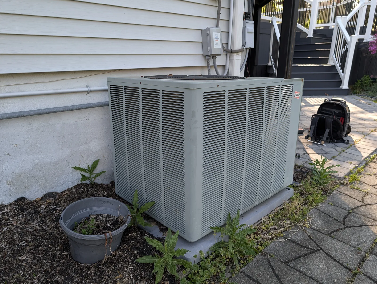 Outdoor AC condenser installed beside a Monmouth County, NJ home