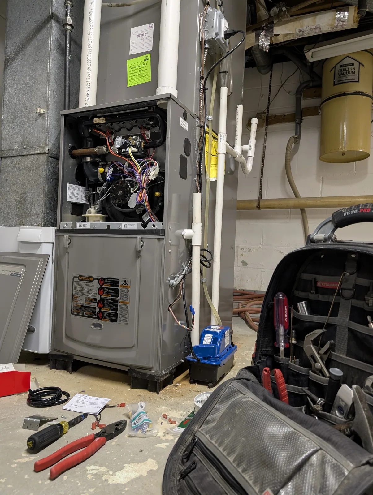 High-efficiency furnace opened during service in a Freehold, NJ basement