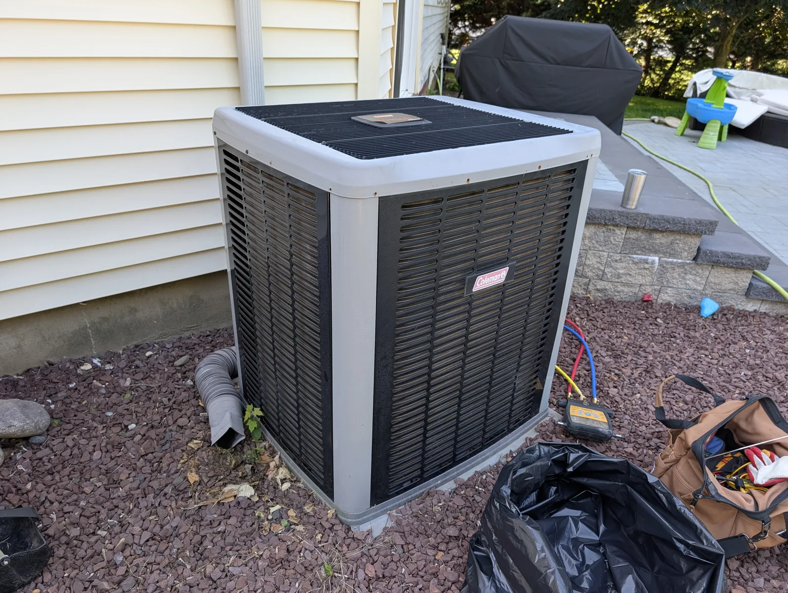 New Coleman AC condenser installed beside a Monmouth County, NJ home