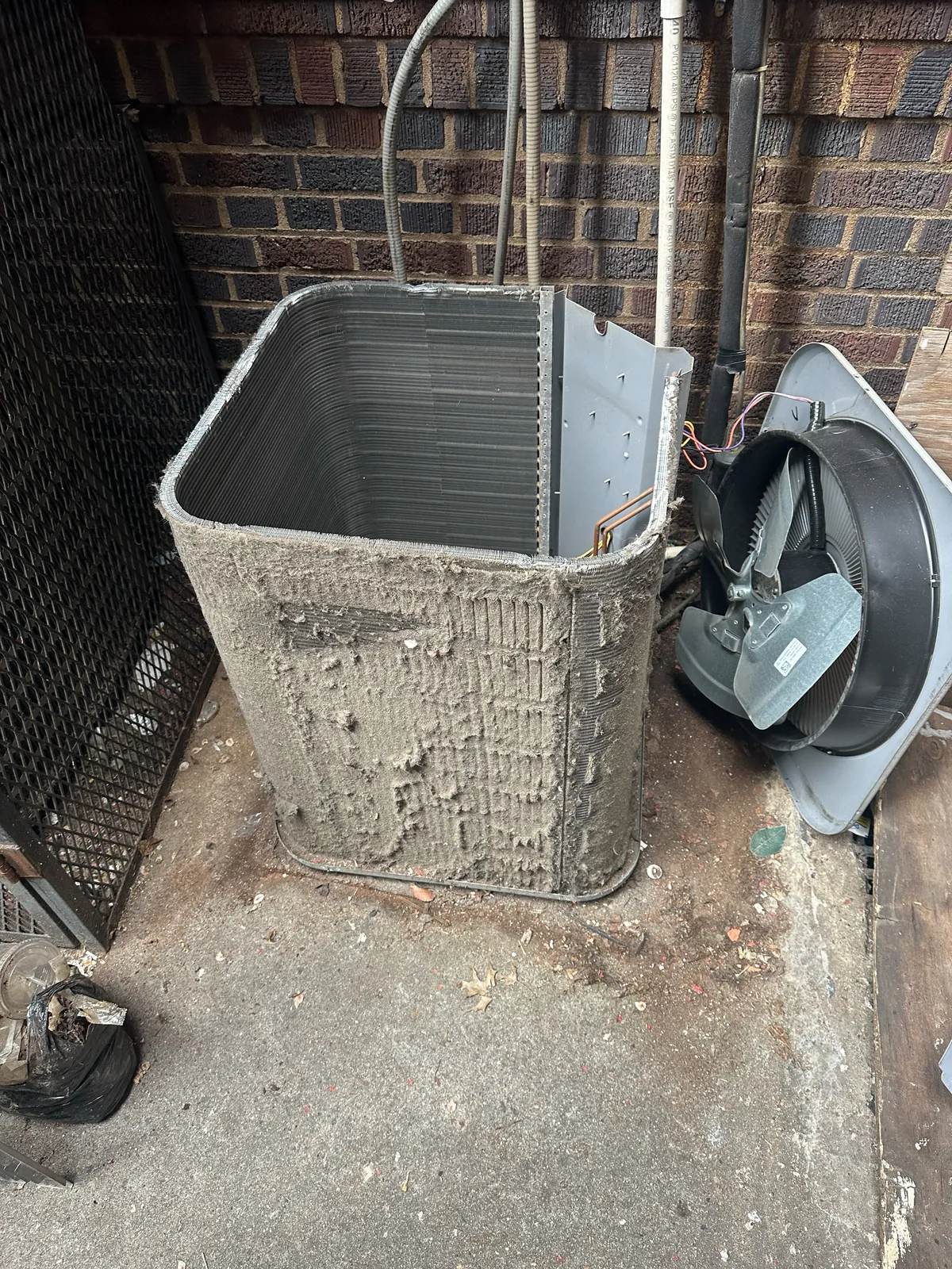 Heavily clogged condenser coil pulled for cleaning during AC service in Freehold, NJ