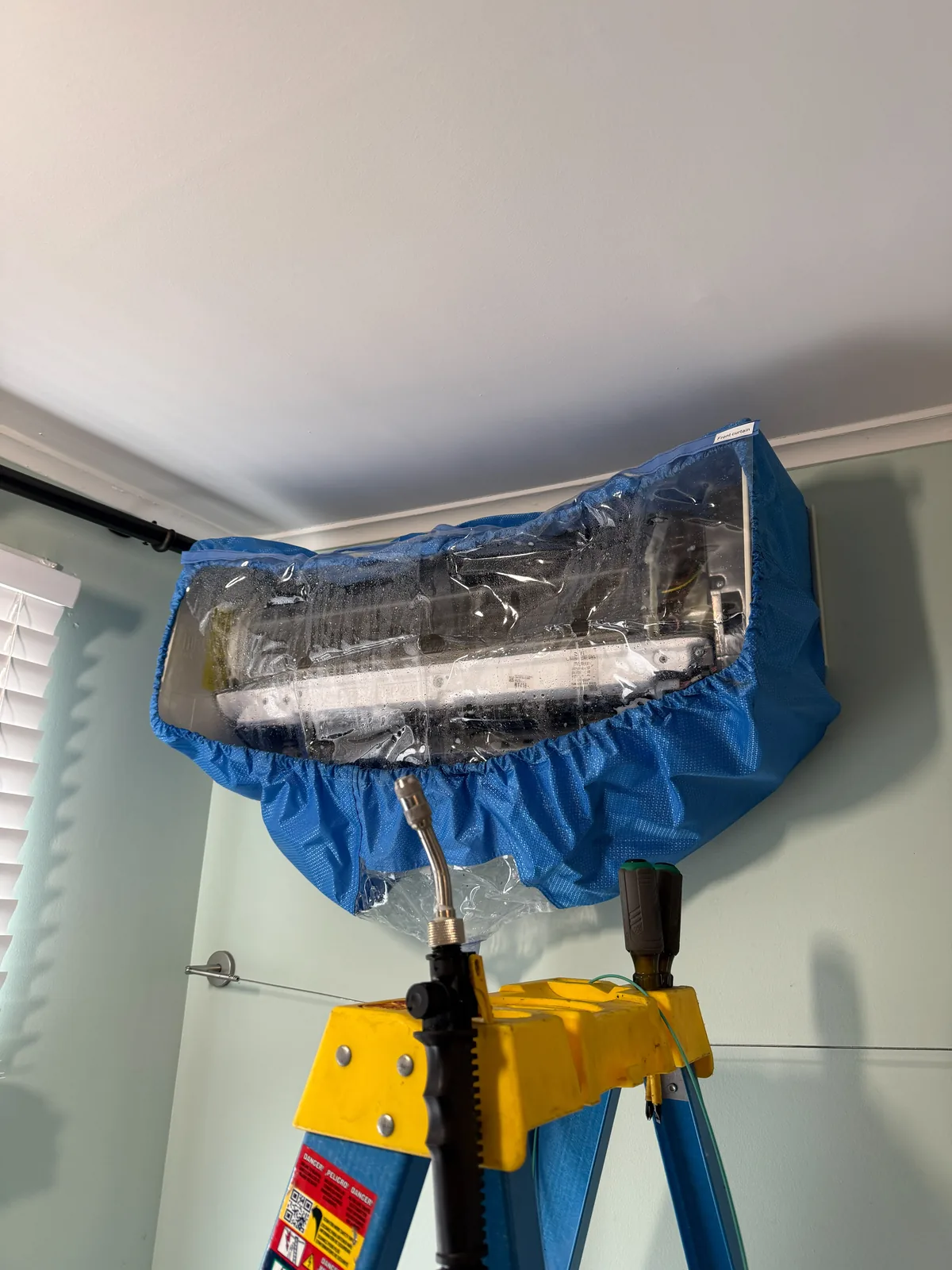 Technician deep-cleaning a wall-mounted mini split head in a Freehold, NJ home