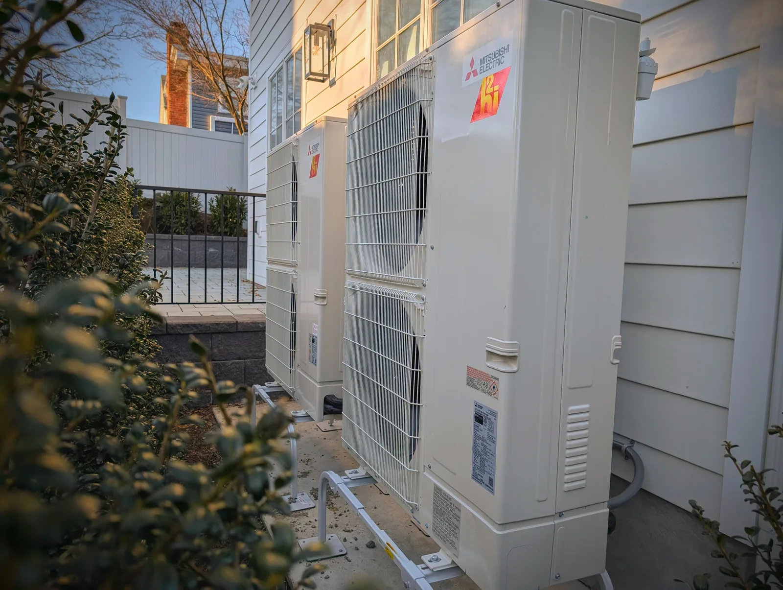 Mitsubishi Hyper-Heat heat pump condensers beside a home in Monmouth County, NJ