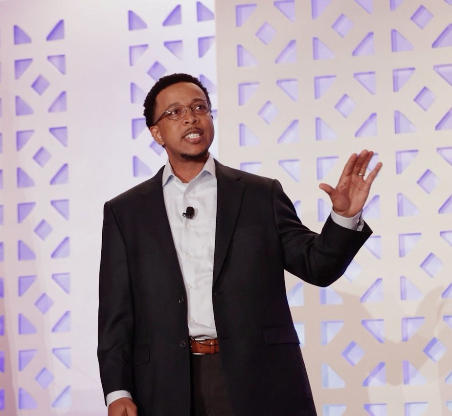 Marcus G. Phillips on stage mid-keynote