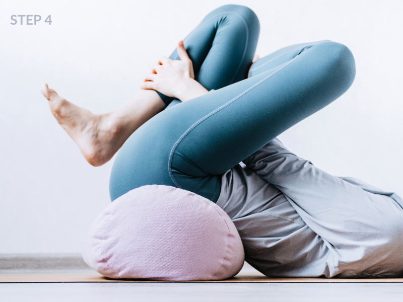 Woman stretching in teal leggings on yoga mat — intentional movement self-care routine