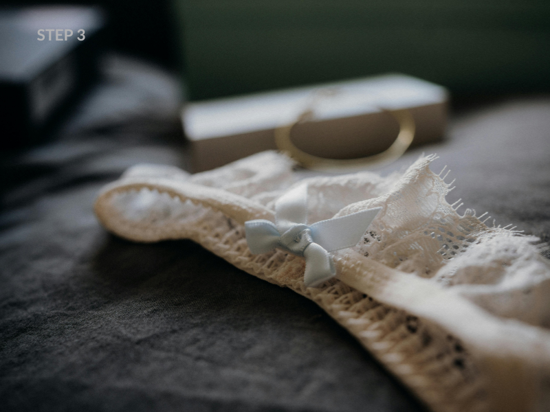 Close-up of delicate ivory lace lingerie on silk — luxury Italian lace boudoir
