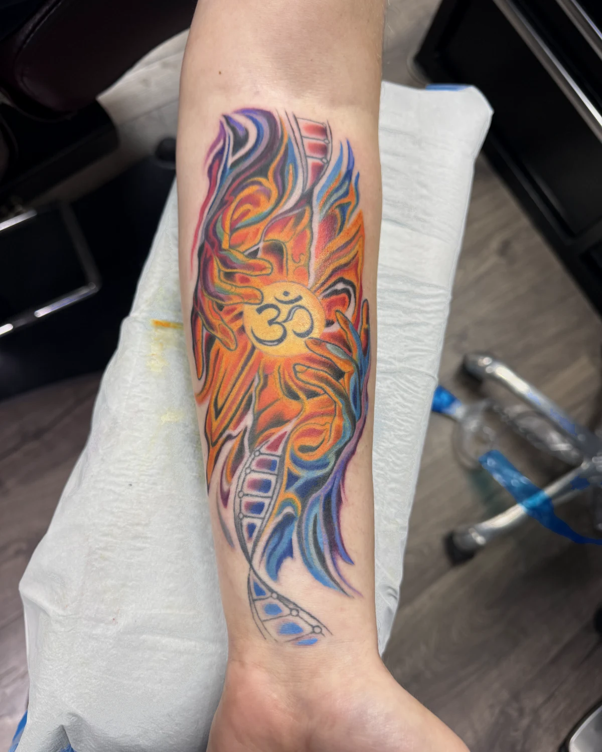 Abstract color Om symbol tattoo by Nicole Miller in Missoula Montana