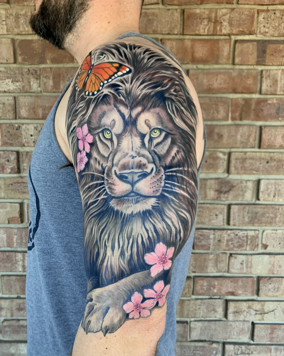 Color lion and flowers tattoo by Nicole Miller in Missoula Montana