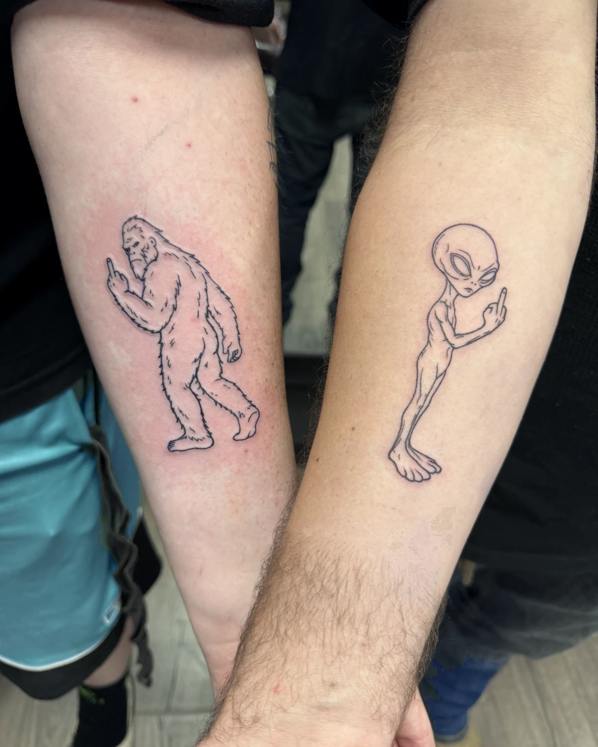 Matching Bigfoot and alien color tattoos by Nicole Miller in Missoula Montana
