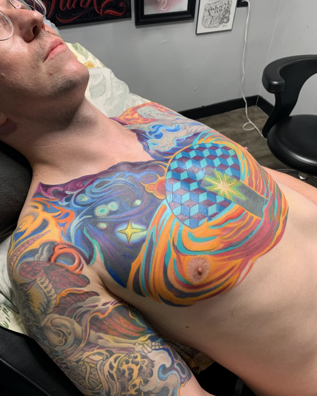 Color psychedelic chest tattoo with surreal ornamental imagery by Nicole Miller in Missoula Montana