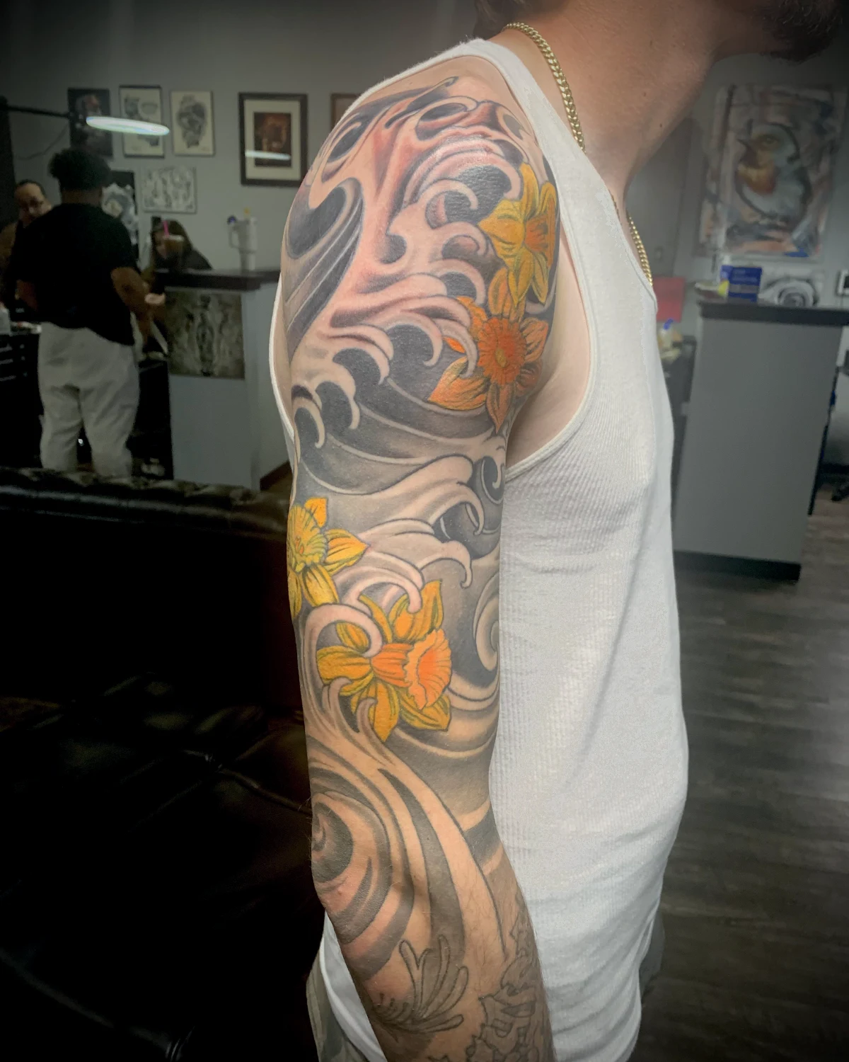 Color ocean wave and flower tattoo by Nicole Miller in Missoula Montana